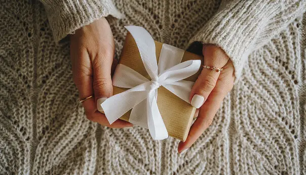 Hands holding a wrapped gift box