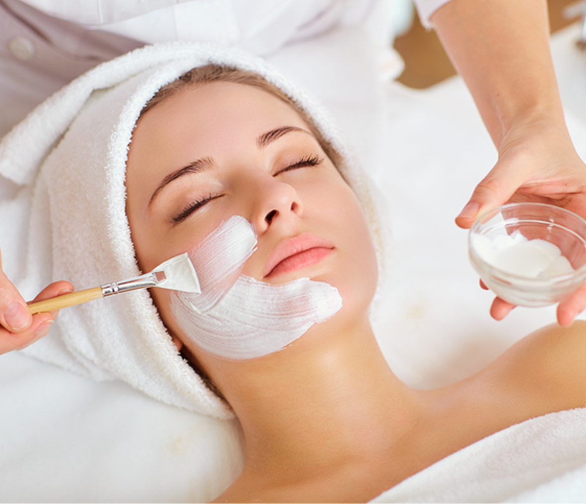 Woman receiving facial mask treatment