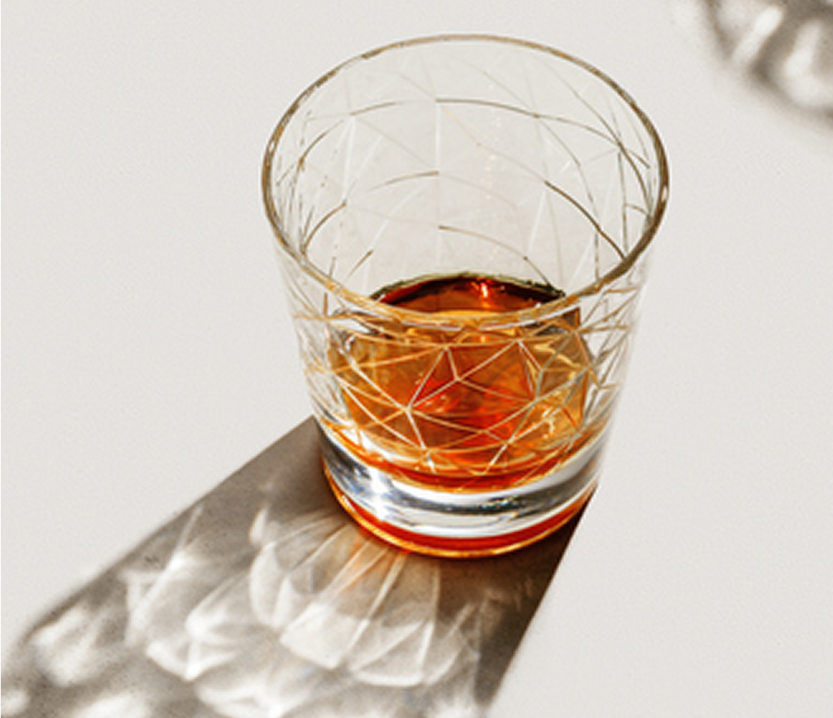 Crystal glass with amber liquid