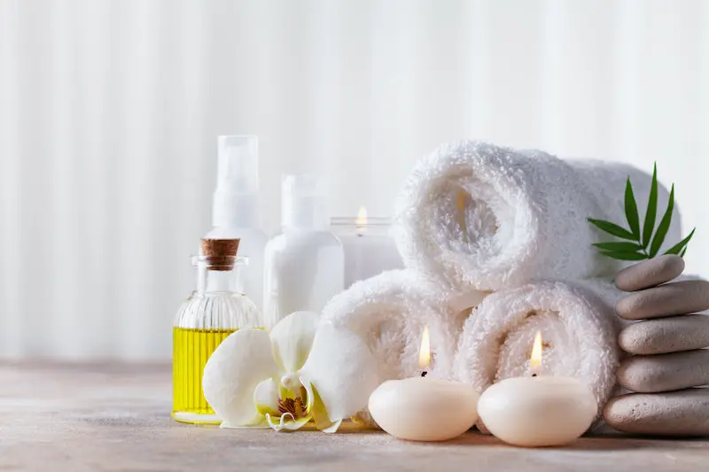 Relaxing spa setup with oil and flowers