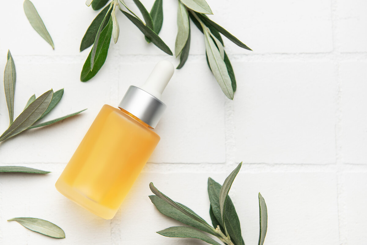 Yellow dropper bottle with green leaves