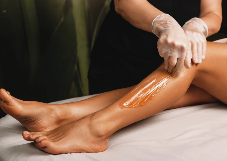 Applying wax on leg
